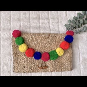 AMERICA & BEYOND Straw Clutch with Large Pom Poms